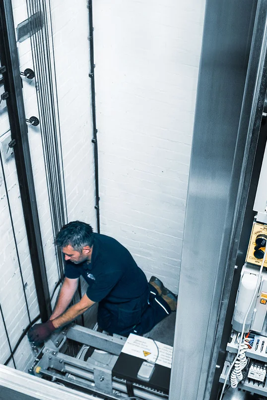 a man fixing a lift